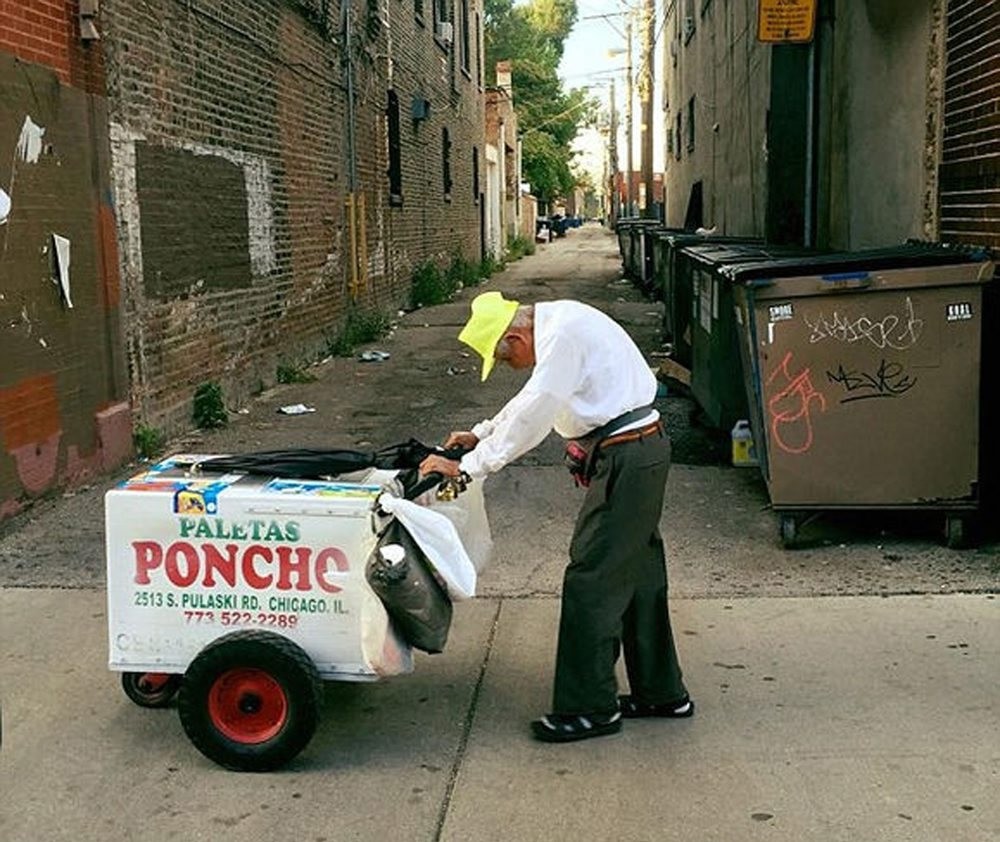 Fidencio Sanchez pushes his cart down the street, Monday, Sept.12, 2016, in Chicago