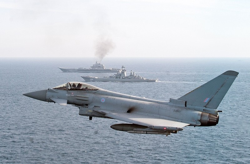 A Royal Air Force Typhoon aircraft joins others and a Royal Navy warship in an operation to escort the Russian Petr Velikiy (C) and the Russian aircraft carrier Admiral Kuznetsov (AFP Photo)