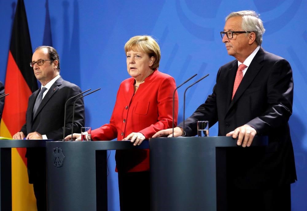 French President Francois Hollande, German Chancellor Angela Merkel and European Commission President Jean-Claude Juncker with representatives of the European Round Table of Industrialists in the chancellery in Berlin, Germany, Sept. 28.