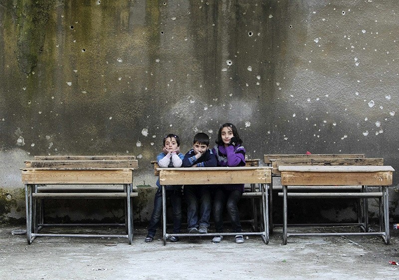 Children sit on school benches at Al-Tawheed school in Aleppo in this January 1, 2013 file photograph. (Reuters Photo)