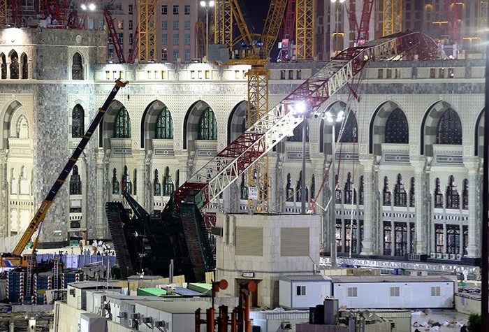 A towering construction crane, center, is seen collapsed over the Grand Mosque, in Mecca, Saudi Arabia, early Saturday morning, Sept. 12, 2015 (AP Photo)
