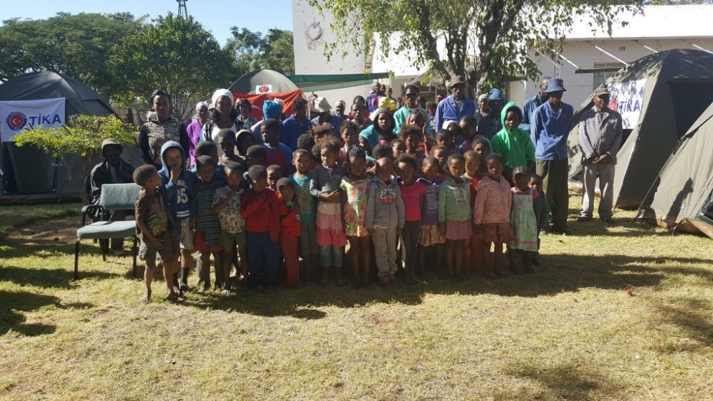 Namibian children pose for a photo after delivery of humanitarian aid by TIKA officials. 
