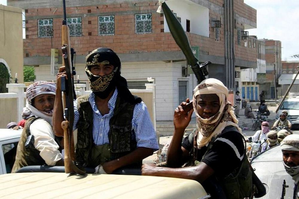 Members of Ansar al-Sharia, an al-Qaida affiliated group, carrying their weapons as they ride in the back of a truck in the southern Yemeni town of Jaar.