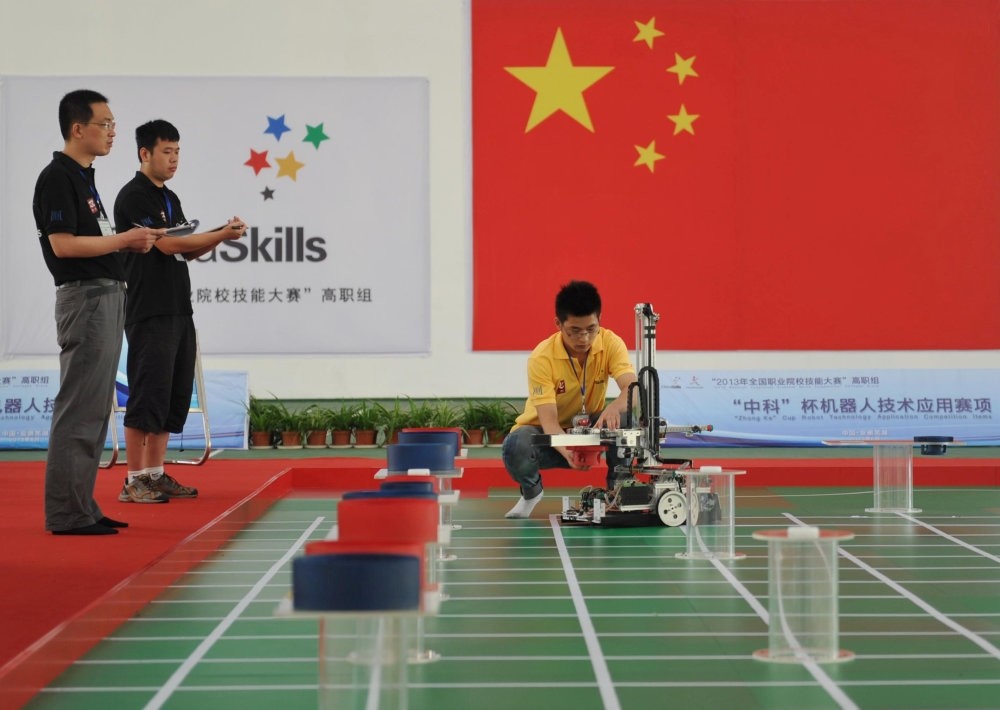A participant operates a robot during a competition in Wuhu, Anhui province.