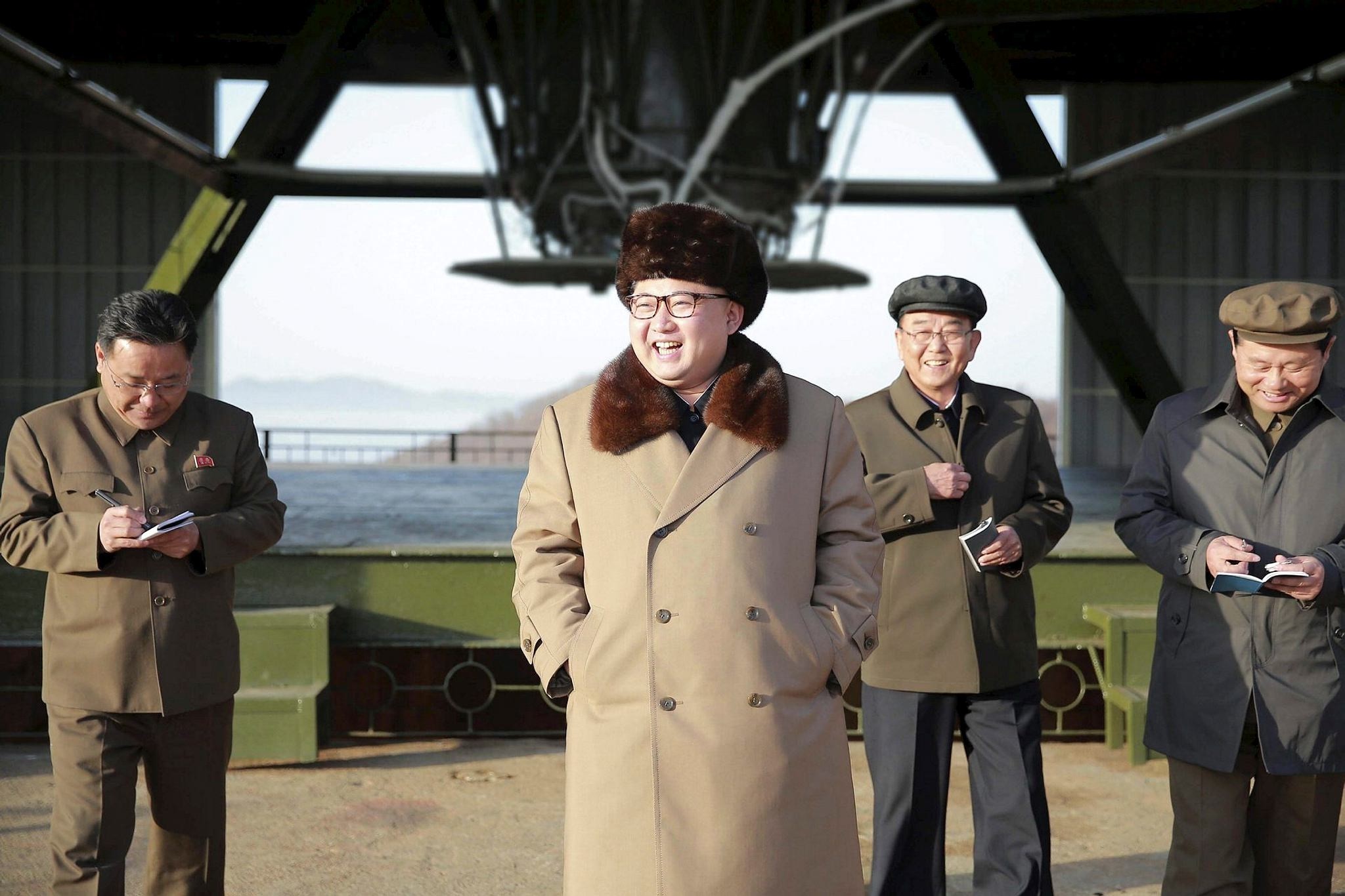 North Korean Supreme Leader Kim Jong Un smiles as he visits Sohae Space Center in Cholsan County, North Pyongan province for the testing of a new engine for an ICBM (KCNA/Reuters)