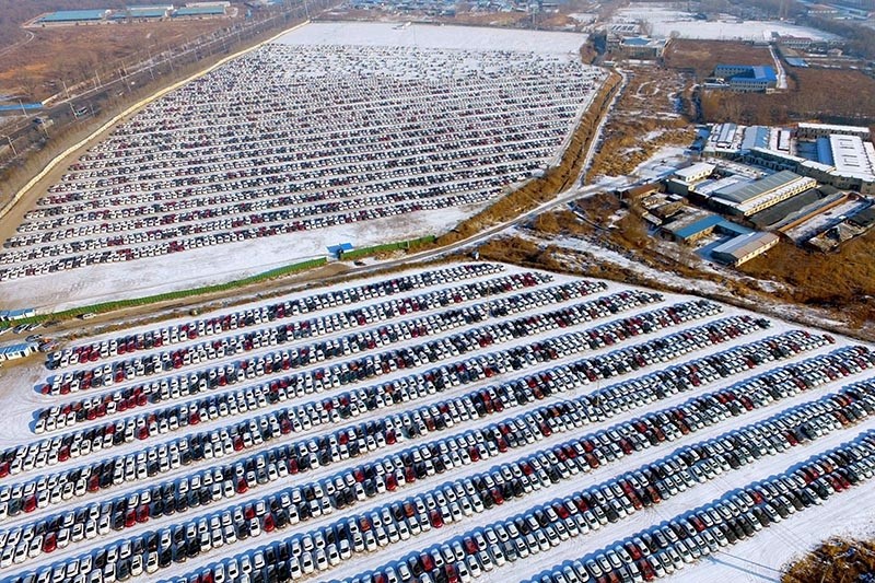 his aerial photo taken on January 16, 2017 shows new cars lined up at a parking lot in Shenyang, northeast China's Liaoning province. (AFP Photo)
