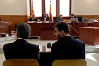 Barcelona's Lionel Messi, right, and his father Jorge Horacio Messi sit in court in Barcelona, Spain, Thursday June 2, 2016.   AP Photo