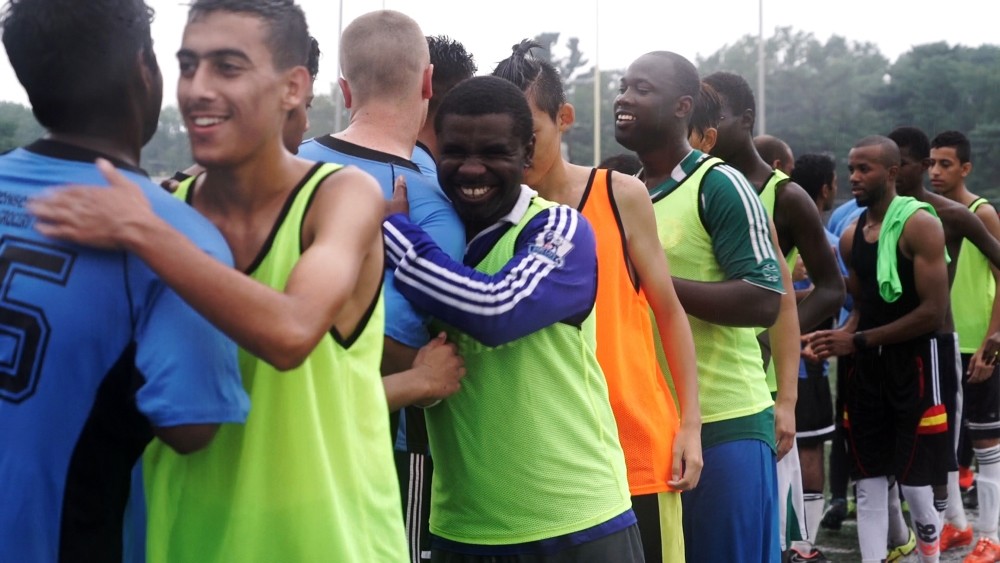 Members of Team Nigeria and Team India shake hands after a friendly soccer match.