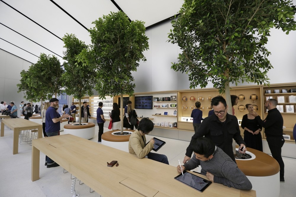 People try products in the u2018Genius Groveu2019 during a preview of the new Apple Union Square Store in San Francisco.