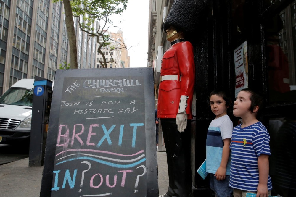 Children standing next to a chalkboard in Manhattan, U.S. on June 24, 2016, advertising the Brexit on the day the British went to a referendum to vote on whether the U.K. should remain in the EU or leave.