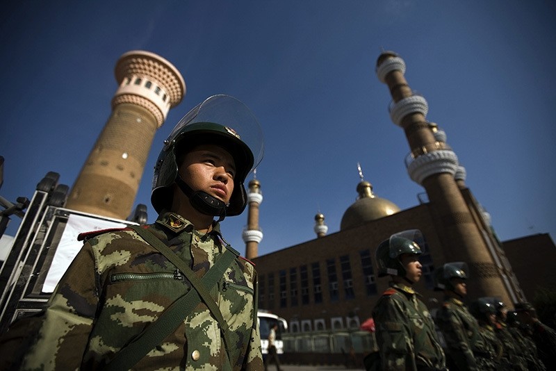 Security forces patrol the entrance to a mosque hours before Friday prayer in Urumqi, Xinjiang province, China, 10 July 2009. (EPA Photo)