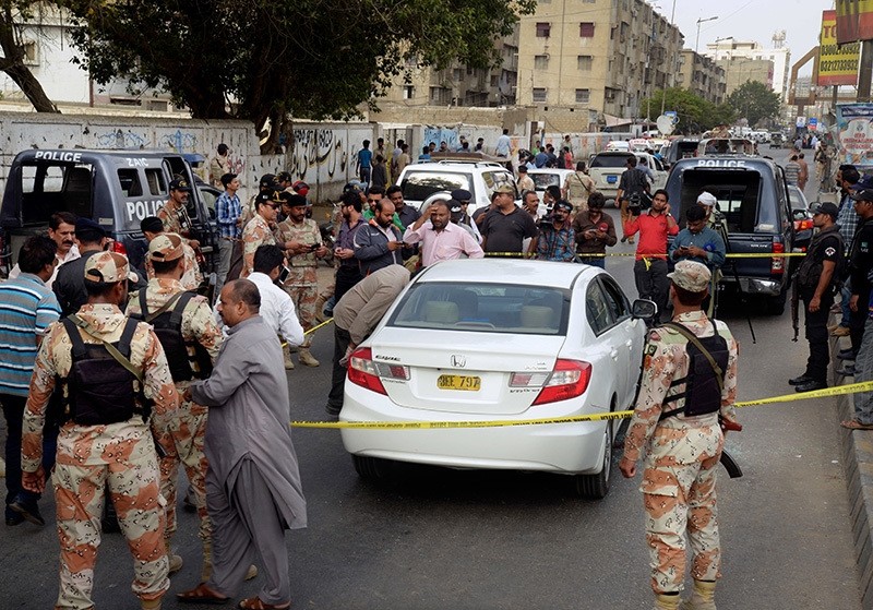 Pakistani investigators and journalists gather around the blood-stained car of famous Sufi singer Amjad Sabri after an attack in Karachi, Pakistan, Wednesday, June 22, 2016. (AP Photo)