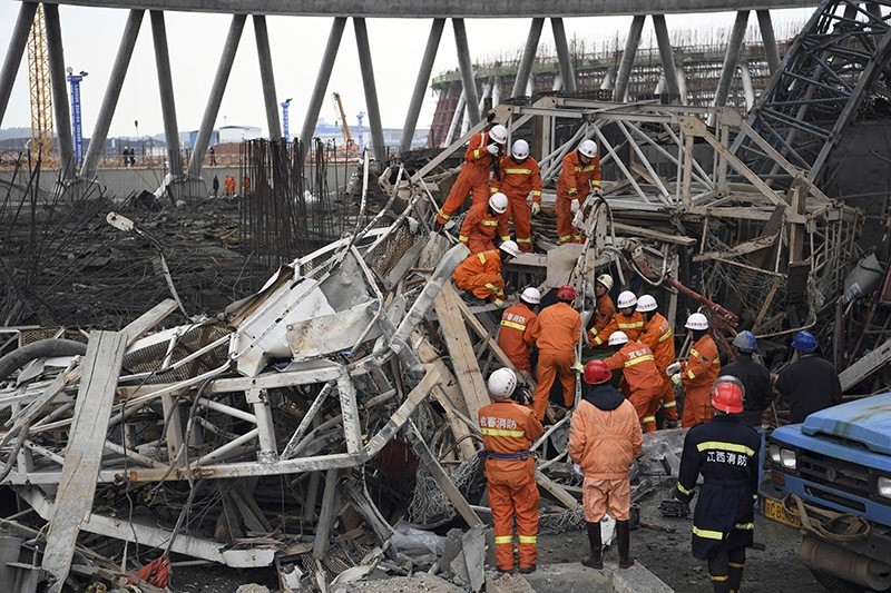 Rescue workers look for survivors after a work platform collapsed at a power plant in eastern China. (AP Photo)