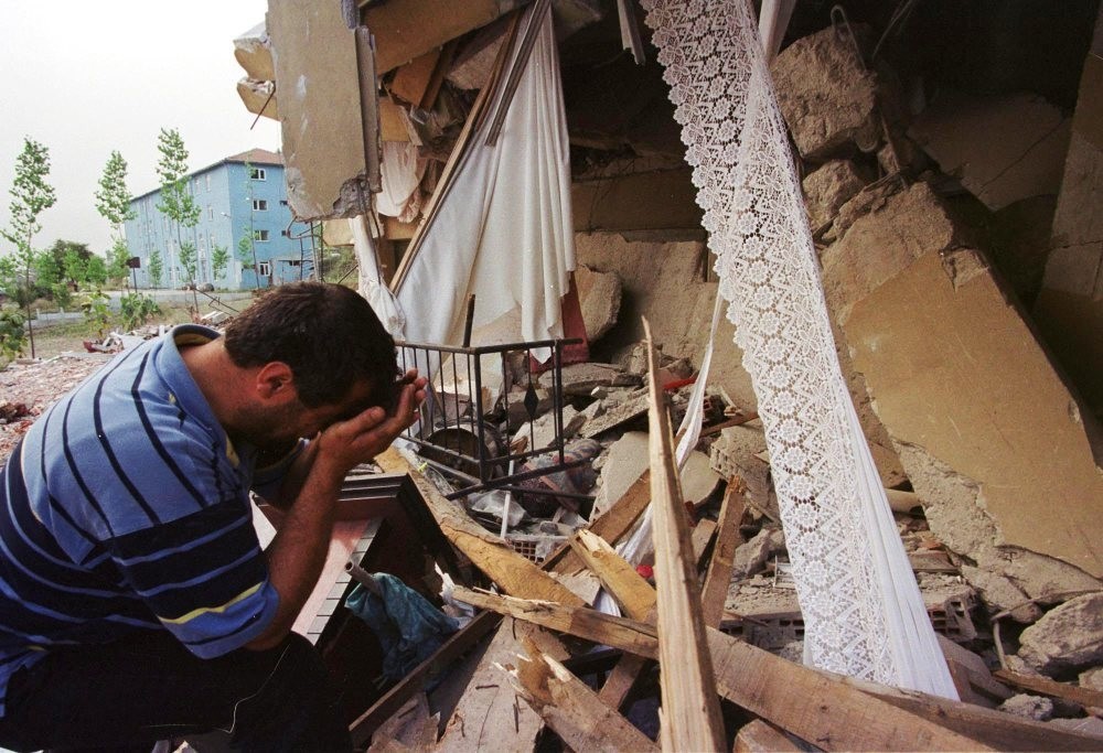 An earthquake survivor weeps next to his destroyed house in the western town of Seymen, u0130zmit in 1999.