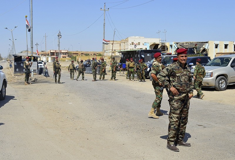 Iraqi security forces wait to do the security check for returning Fallujah residents in Fallujah, 40 miles (65 kilometers) west of Baghdad, Iraq, Saturday, Sept. 17, 2016 (AP Photo)