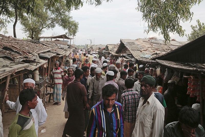 In this Dec. 2, 2016, file photo, Rohingya from Myanmar make their way in an alley at an unregistered refugee camp in Teknaf, Bangladesh. (AP Photo)