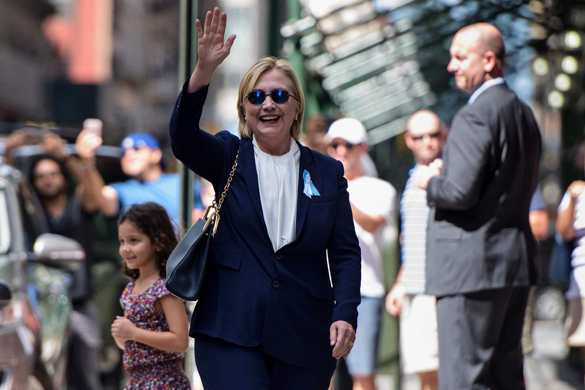 US Democratic presidential nominee Hillary Clinton waves to the press as she leaves her daughter's apartment building after resting on September 11, 2016, in New York. (AFP Photo)