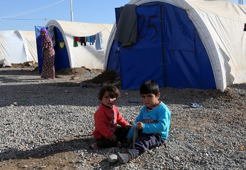  Iraqi displaced children from Mosul sit on the ground near the tents at Khazir camp, east of Mosul, northern Iraq, 04 December 2016 (EPA Photo)