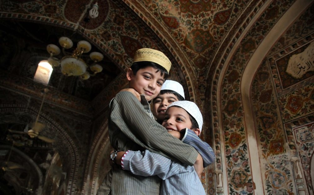 Children greet each other after offering bayram prayers at a mosque.