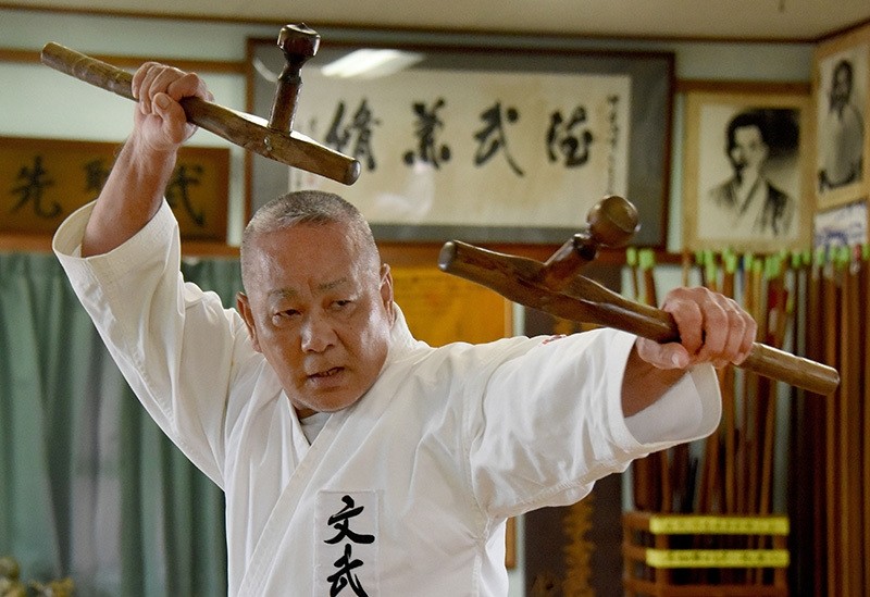 Karate master Takashi Nakamori, a high-ranking expert of the Okinawa Kobudo traditional weapons system, using a pair of ,tonfa, to demonstrate his skills at a training hall in Naha, Okinawa prefecture, June 18, 2016. (AFP Photo)