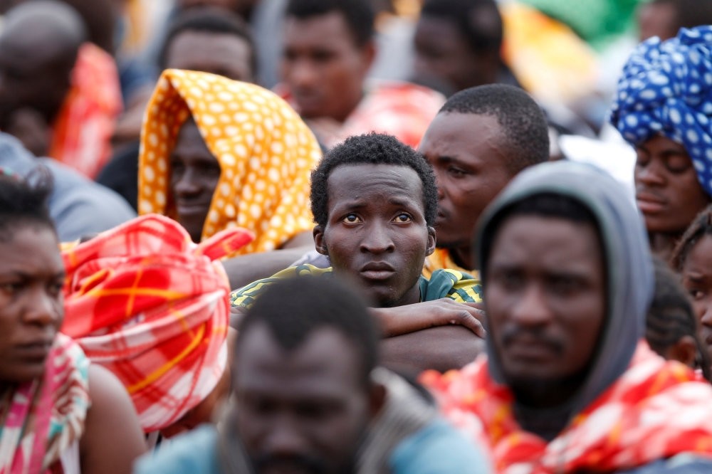 Migrants disembark from a vessel in the Sicilian harbour of Augusta, Italy, June 24.
