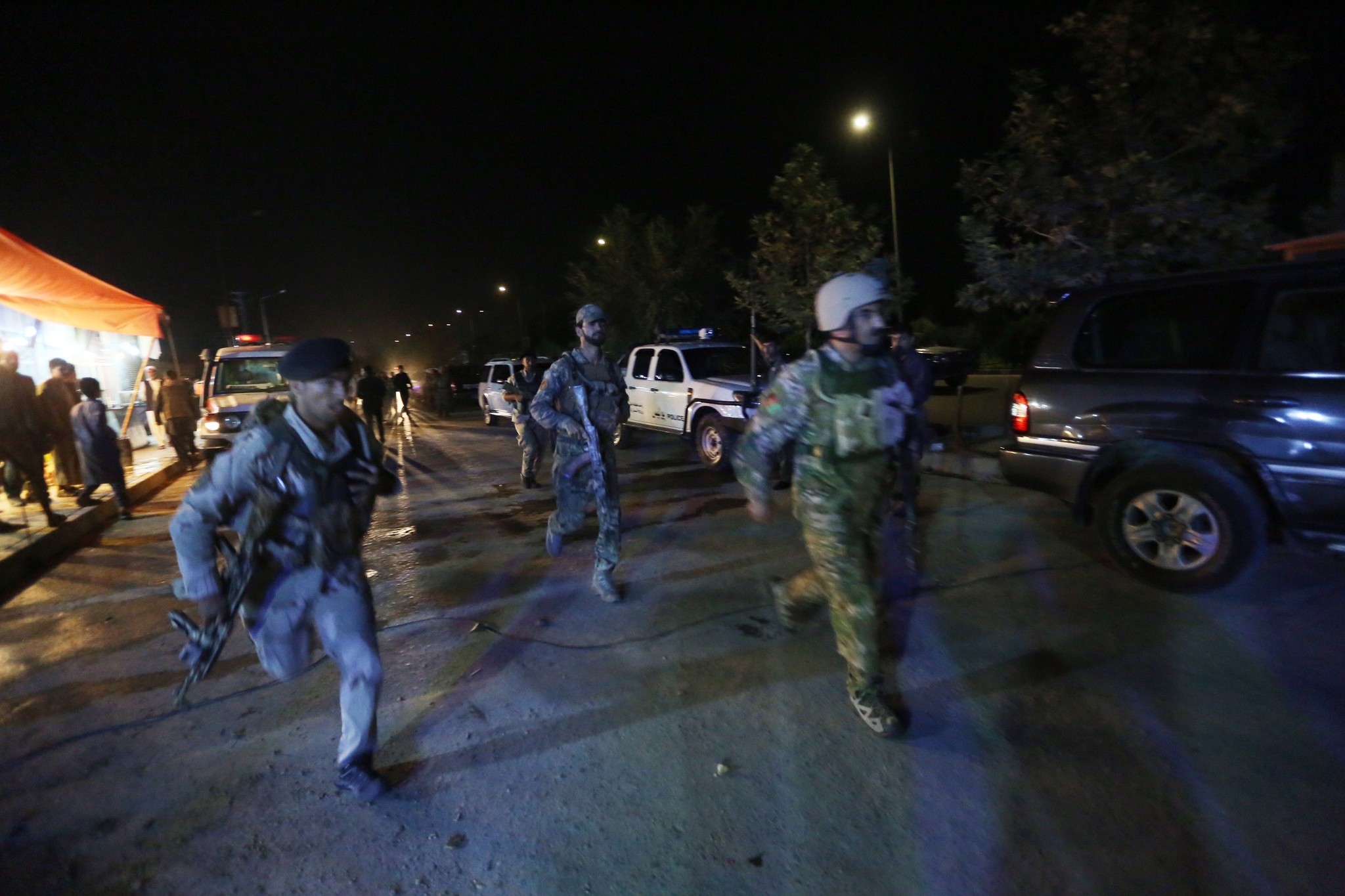 Afghan security forces rush to respond to a complex Taliban attack on the campus of the American University in the Afghan capital Kabul on Wednesday, Aug. 24, 2016. (AP Photo)