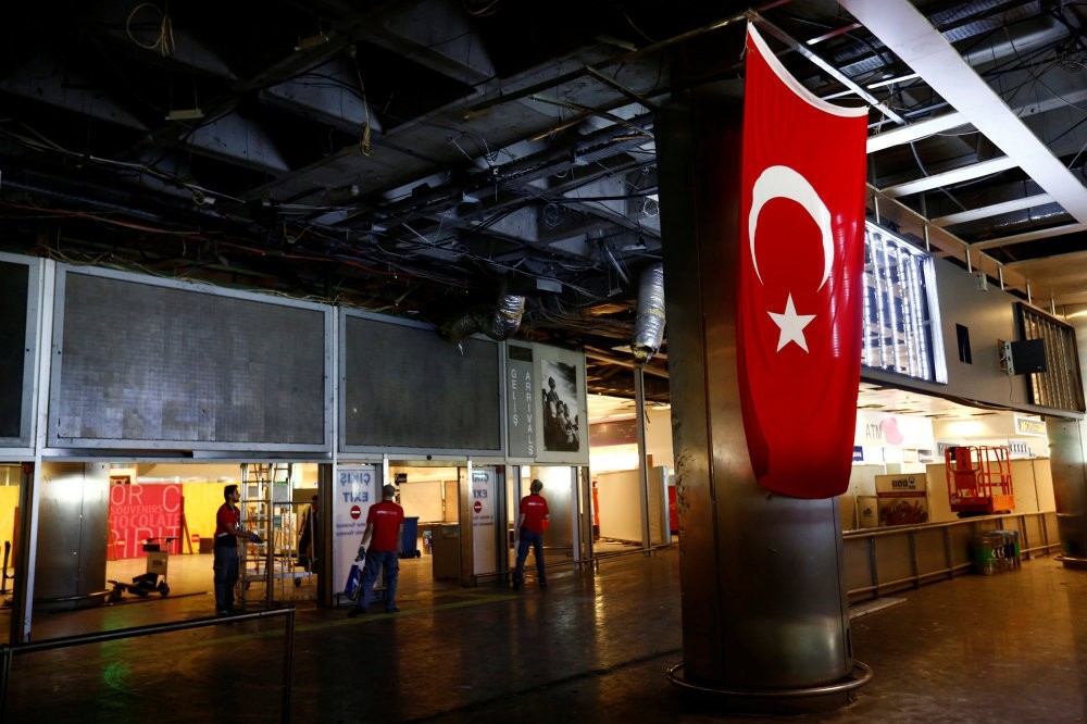 Workers repairing the damaged sections of the terminal building at Turkey's largest airport, Istanbul International Atatu00fcrk Airport, following the explosions on Tuesday, June 29, 2016.