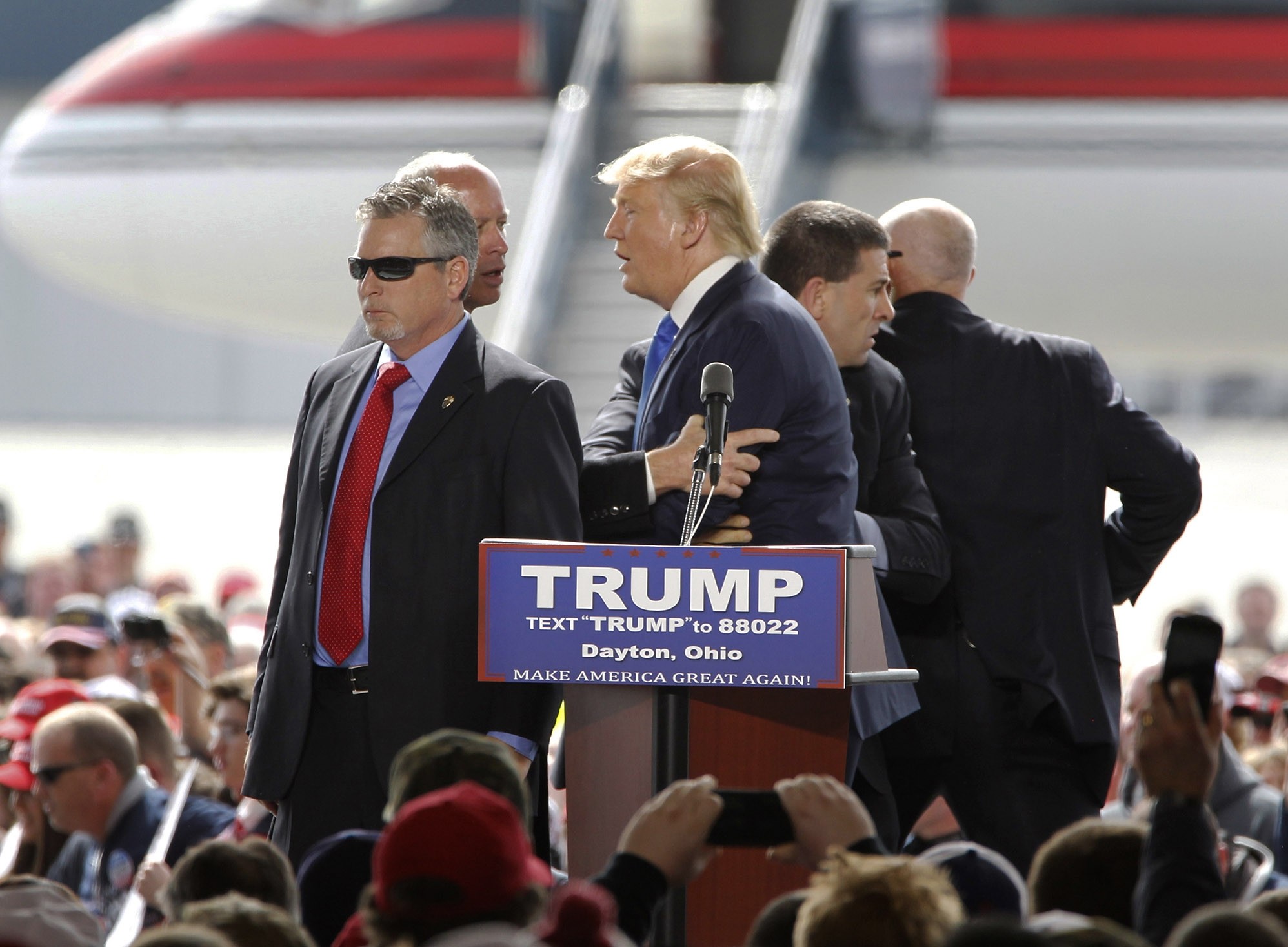  Security surround GOP presidential candidate Donald Trump after a man rushed the stage during a campaign rally at Dayton International Airport in Vandalia, Ohio. (AP Photo)