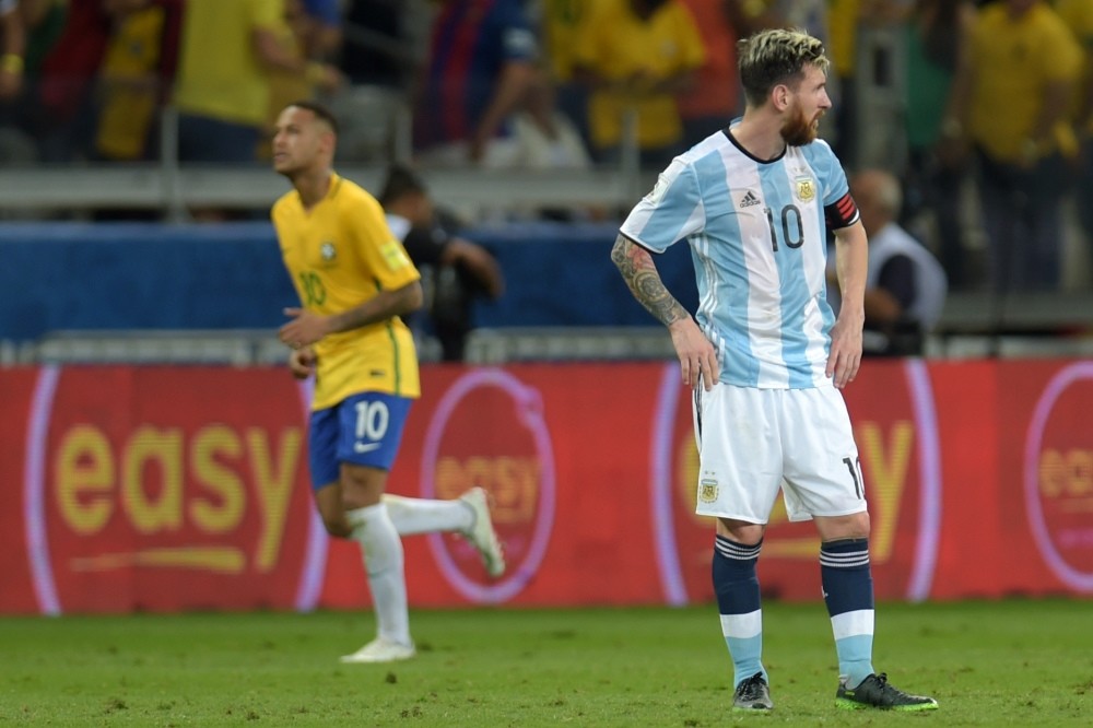 Argentinau2019s Lionel Messi stands in dejection after Brazilu2019s Neymar scored the teamu2019s second goal during their 2018 FIFA World Cup qualifier football match in Belo Horizonte.