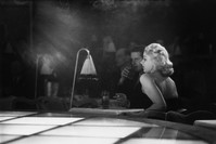 9th December 1950: A couple sitting next to the stage for a floor show at u201cLa Nouvelle Eve,u201d the newest and most expensive night spot in Paris.