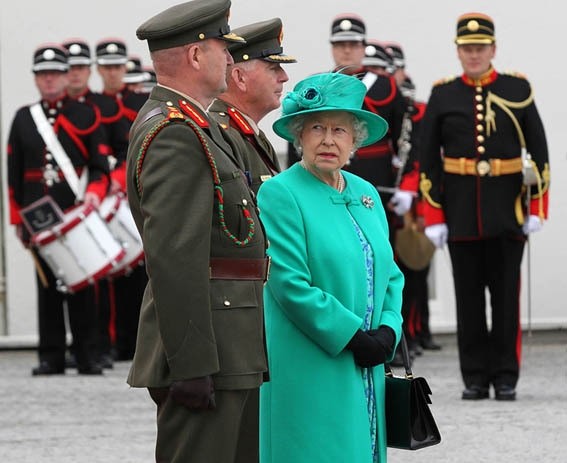 Queen Elizabeth II looks back at Irish Defence Guard Chief of Staff, Lt. Gen. Sean McCann, at the Aras an Uachtarain, in Dublin, 2011. 