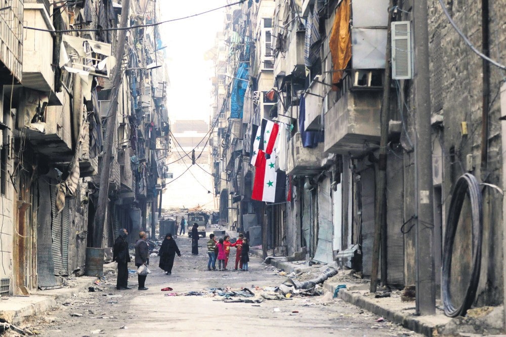 Syiran children playing amid destroyed buildings in Aleppo's formerly moderate opposition-held al-Shaar neighbourhood, Jan. 21.