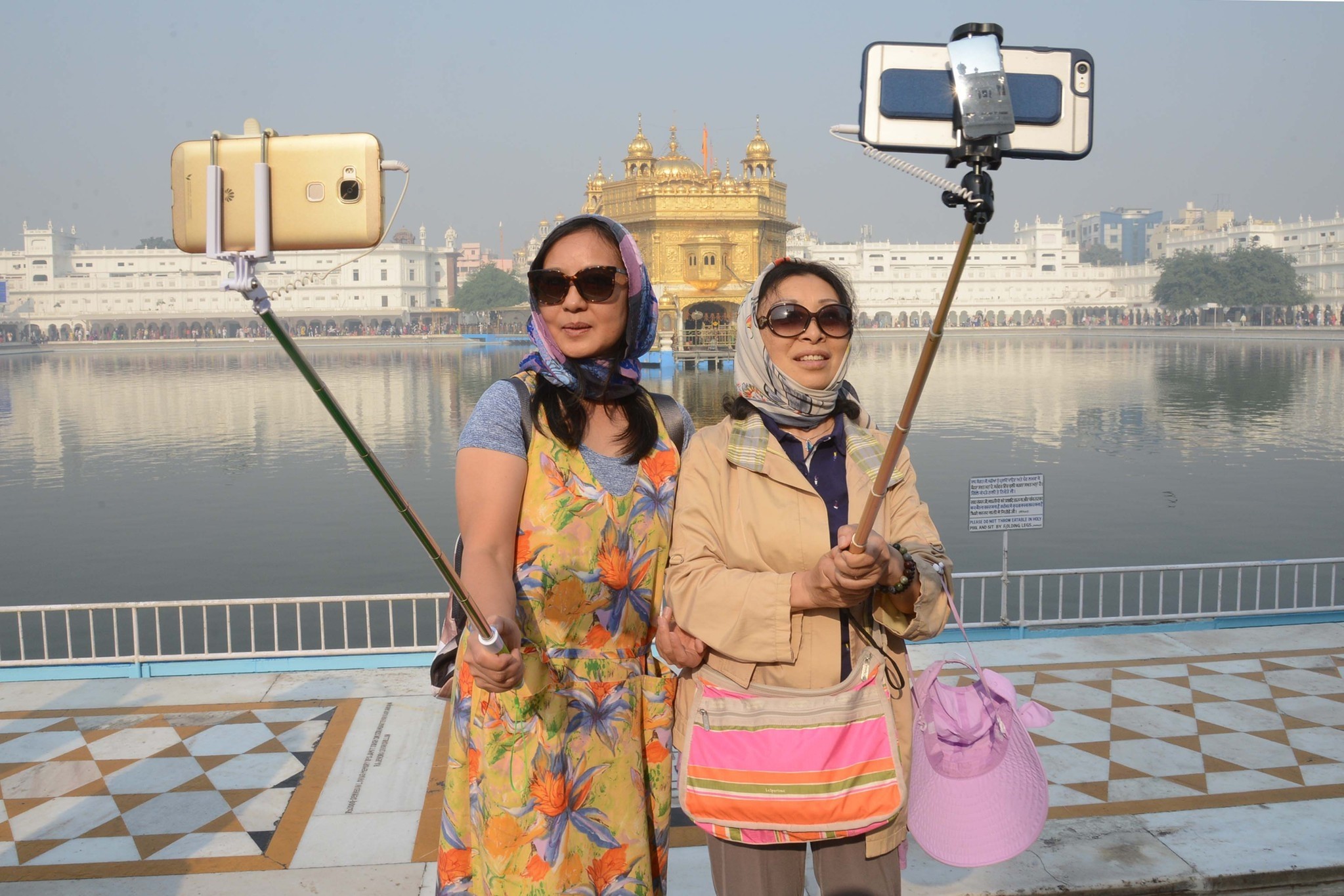 Chinese tourists take a 'selfie' at the Golden Temple in Amritsar on November 14, 2016, as Sikh devotees mark the 547th birth anniversary of Sri Guru Nanak Dev. (AFP Photo)
