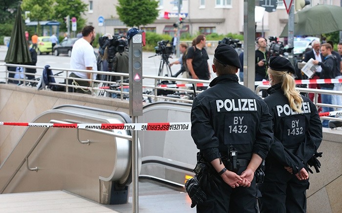 Policemen stand in front of a cordoned-off underground station near the Olympia-Einkaufszentrum shopping centre in Munich, southern Germany, on July 23, 2016, one day after the attack at the shopping centre in Munich. (AFP Photo)