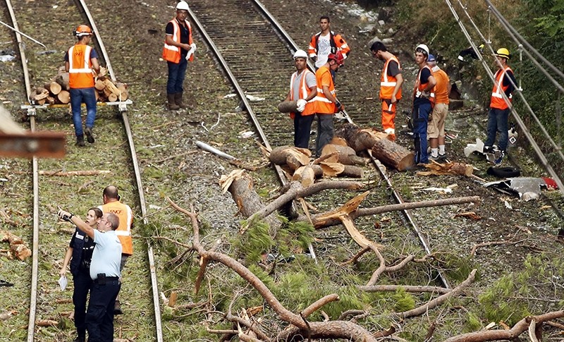Railroad workers and French police officers clean the rails near Saint-Aunes in the South of France, 17 August 2016 (EPA Photo)