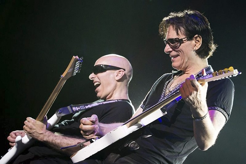 US guitarists Joe Satriani (L) and Steve Vai (R) perform during their G3 tour concert at the Papp Laszlo Budapest Sportsarena in Budapest, Hungary, 01 August 2012. (EPA)
