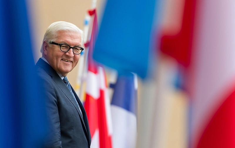 German Foreign Minister Frank-Walter Steinmeier smiles as he stands next to flags on Nov. 8, 2016. (AFP Photo)
