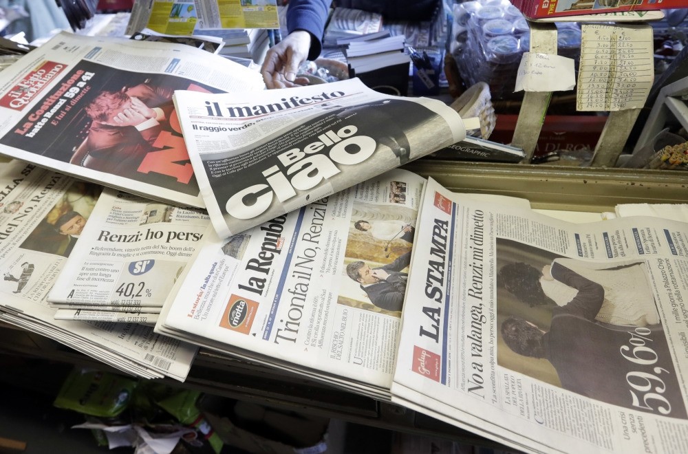 Newspaper headlines showing Italian Premier Matteo Renzi's resignation following the result of Sunday's constitutional referendum, at a newsstand in Rome, Dec. 5, 2016. 