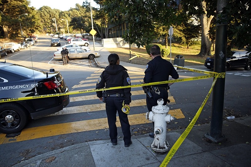 San Francisco Police stand at the site of a shooting outside the June Jordan School for Equity and City Arts and Technology High School, which share a campus, San Francisco, Calif., Oct. 18, 2016. (AP Photo)