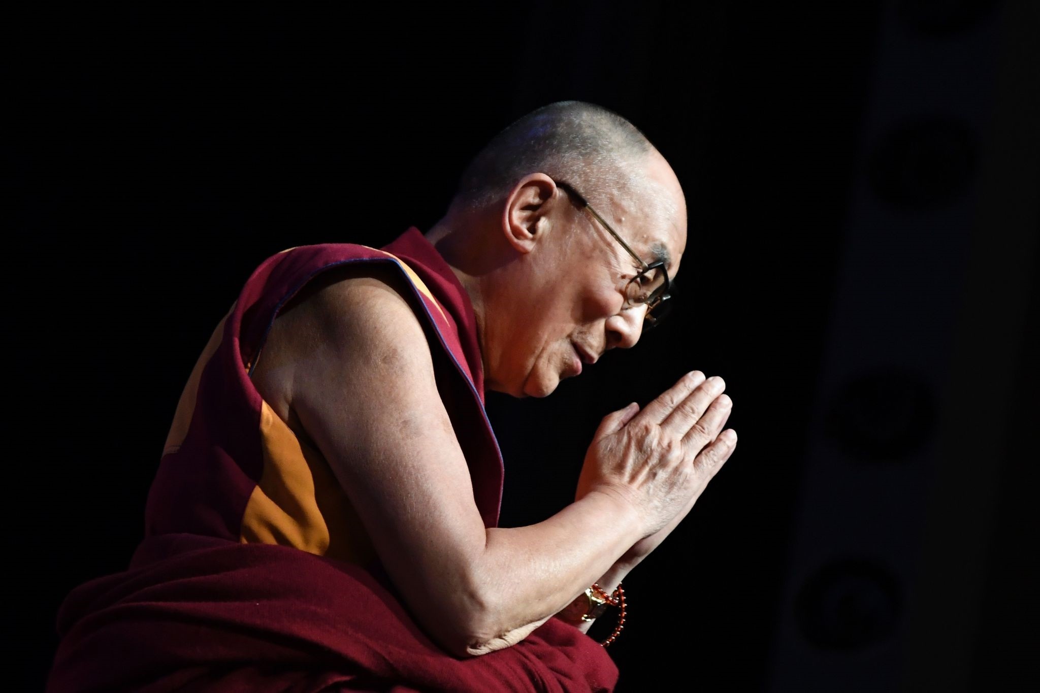 The Dalai Lama gestures during a group hearing at the Palais des Congres, on September 13, 2016 in Paris, during his visit to France. (AFP PHOTO)
