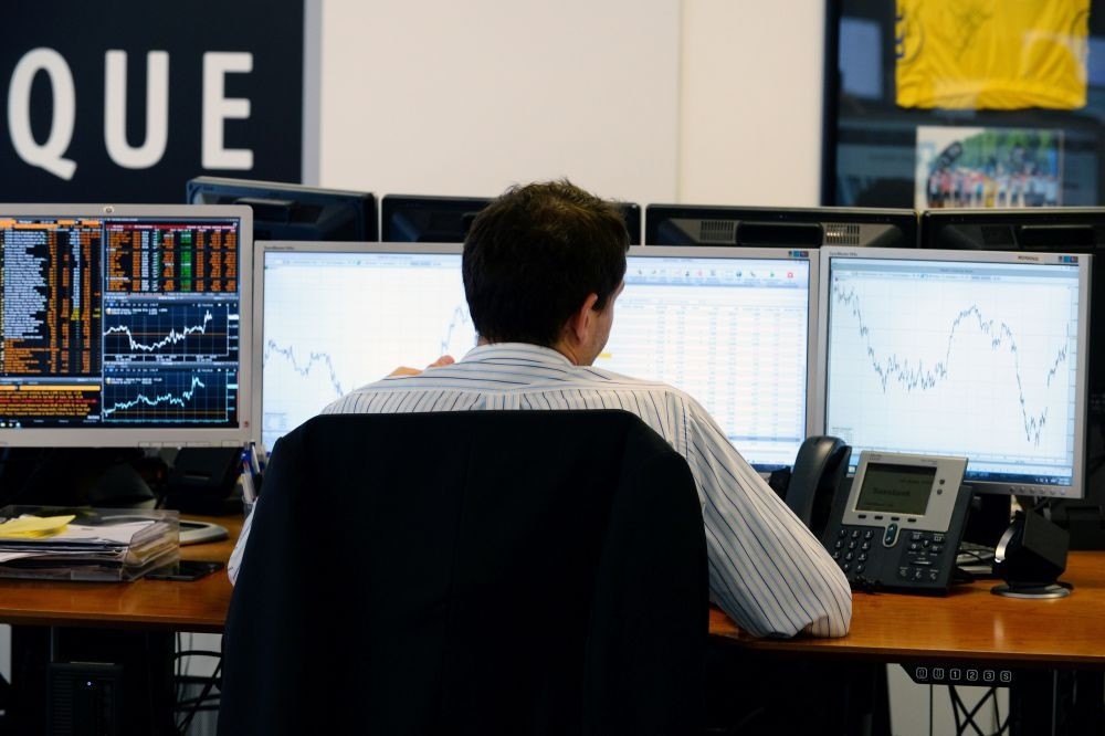 A trader checks his screens at investment bank Saxo Banque in Paris. European stocks rallied and the pound hit its highest level on Thursday as markets expected the Remain camp to come out on top in Britain's referendum on EU membership.