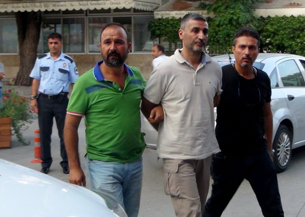 Police officers accompany Gu00f6khan Su00f6nmezateu015f to a courthouse in the southwestern city of Muu011fla where he was transferred after his capture in Ankara.