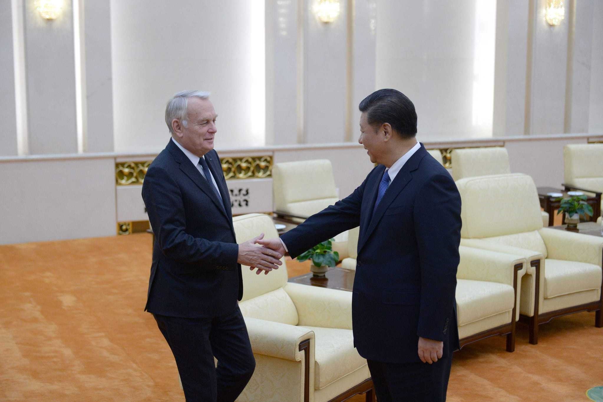 Chinese President Xi Jinping (R) shakes hands with French Foreign Minister Jean-Marc Ayrault ahead of their meeting at the Great Hall of the People in Beijing. The French foreign minister is on an official visit to China.