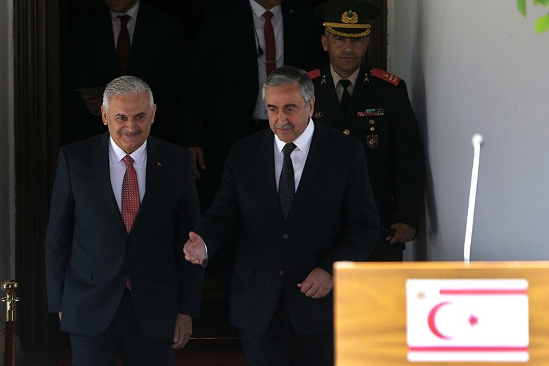 Turkish Prime Minister Binali Yu0131ldu0131ru0131m (L) and Turkish Cypriot leader Mustafa Aku0131ncu0131 leave their meeting following a press conference. (AP Photo)
