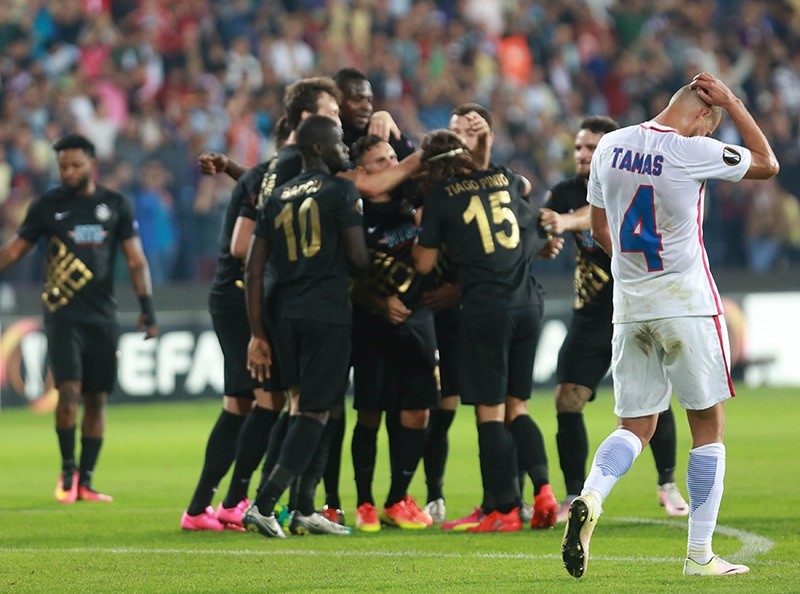 Steaua Bucharest's Gabriel Tamas reacts as Osmanlu0131spor's players celebrate their second goal during the match at Osmanlu0131 Stadium, Ankara, Turkey on September 15, 2016. (AFP Photo)