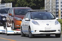 Nissan Motor Co.'S ,Leaf,, with no one inside, pulls a trailer with three other Leafs on it, during a demonstration of the automaker's Intelligent Vehicle Towing system at Nissan Oppama plant in Yokohama, Dec. 5, 2016. (AP Photo)