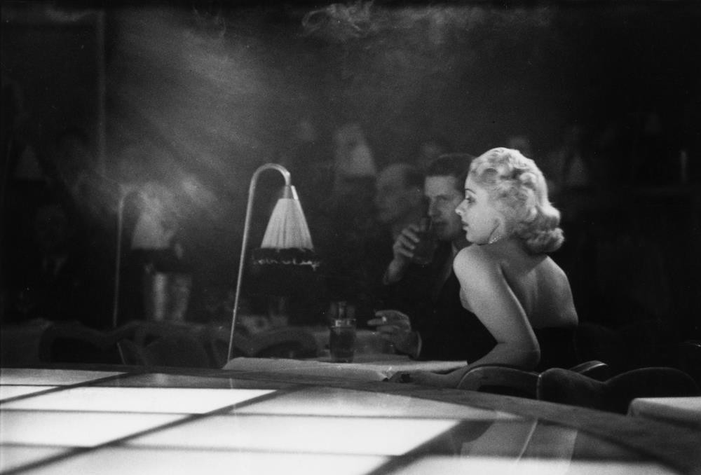 9th December 1950: A couple sitting next to the stage for a floor show at u201cLa Nouvelle Eve,u201d the newest and most expensive night spot in Paris.