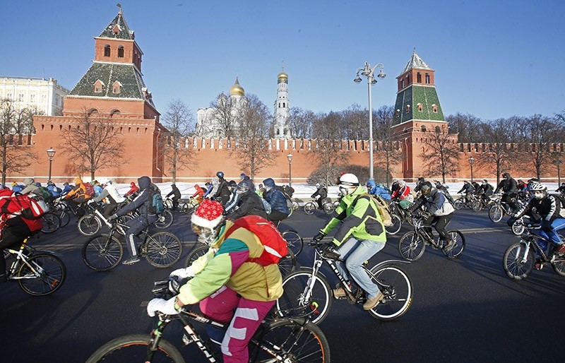 Cyclists pass by the Kremlin as they are taking part in a winter bike parade in Moscow, Russia on January 2017. (EPA Photo)