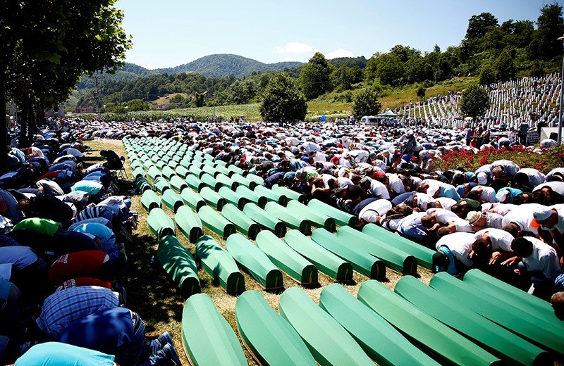 Muslim men pray in front of coffins during mass funeral in Potocari near Srebrenica, Bosnia and Herzegovina July 11, 2016. (Reuters Photo)