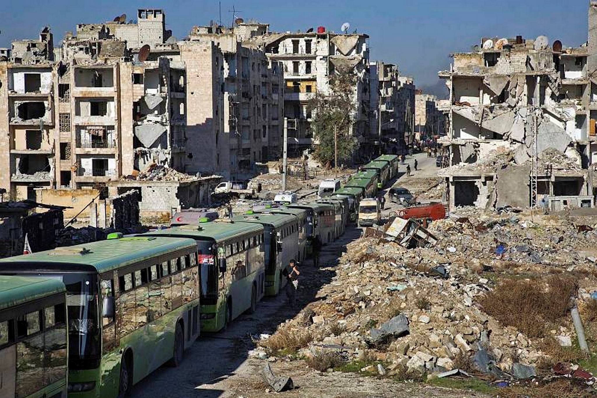 Buses are seen during an evacuation operation of opposition fighters and their families from opposition-held neighbourhoods in the embattled city of Aleppo, Dec. 15